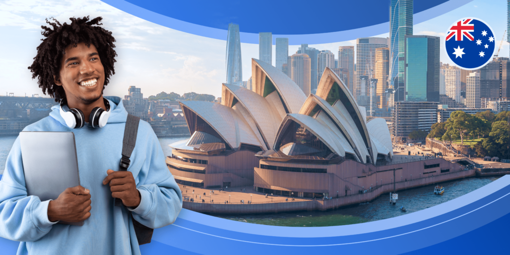 A male international student carrying a bag and a laptop looks upward, toward a framed image of the Sydney Opera house - a large building with a roof shaped like stacked sails on a ship.