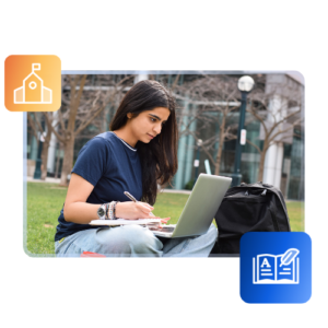 An international student looks at a laptop while sitting in a grassy university quad.