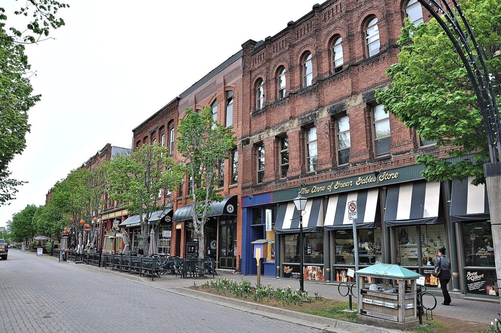 A row of three-storey brick buildings line a quiet street in Charlottetown, PEI