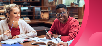 Two international students sit at a table, preparing for exam season.
